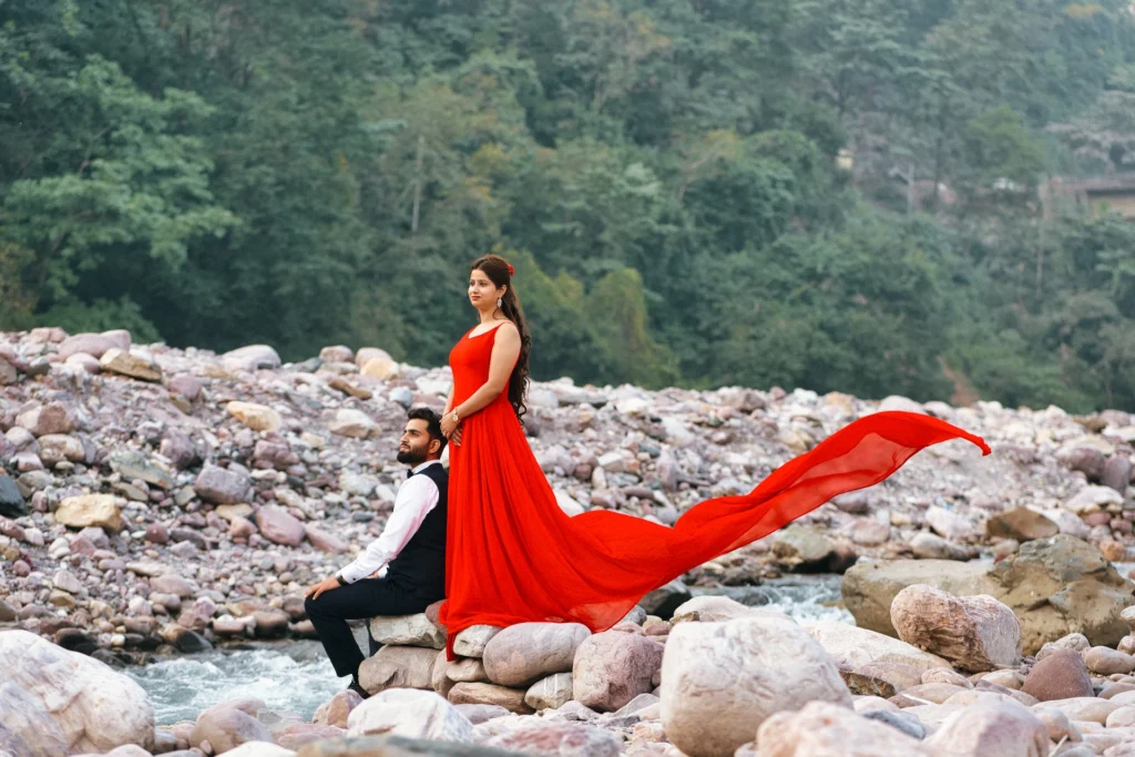 Couple posing on rocky riverside terrain during a Pre-Wedding Shoot in Rishikesh