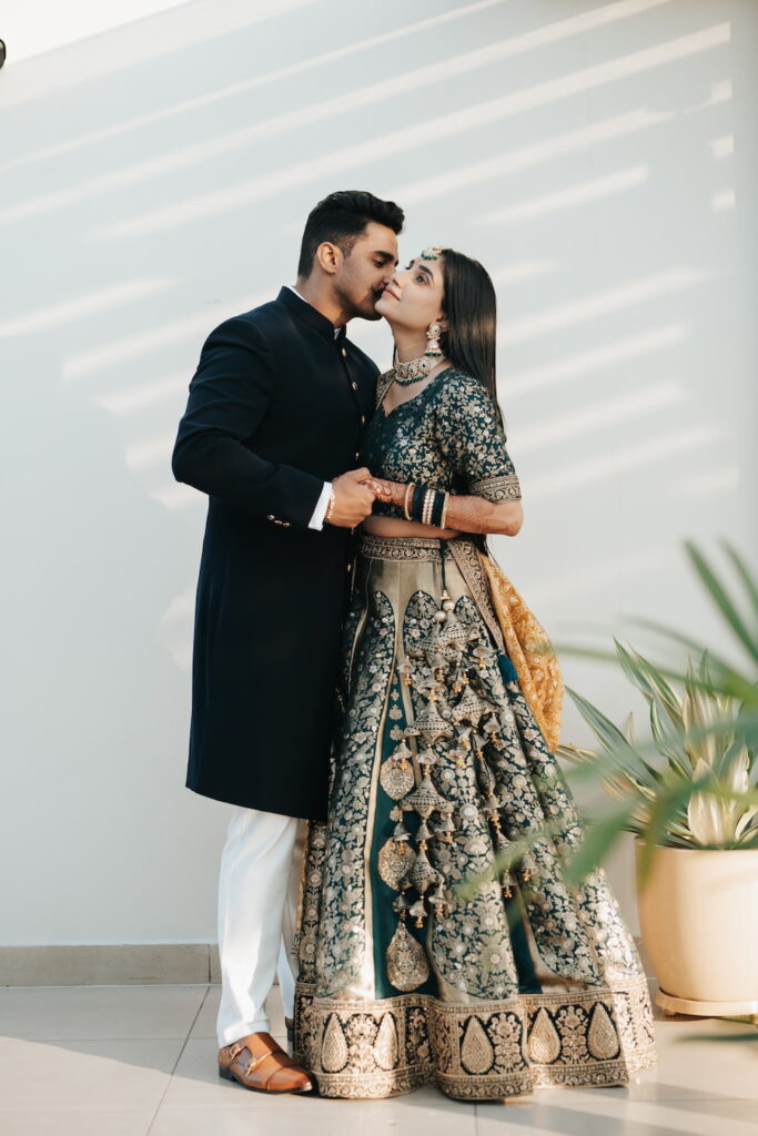 Couple portrait during colorful mehendi ceremony with floral decor