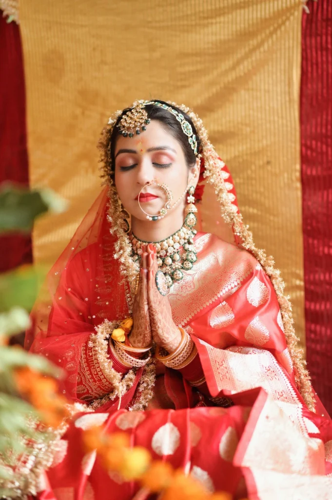 Bride offering prayers during a traditional Hindu wedding ceremony