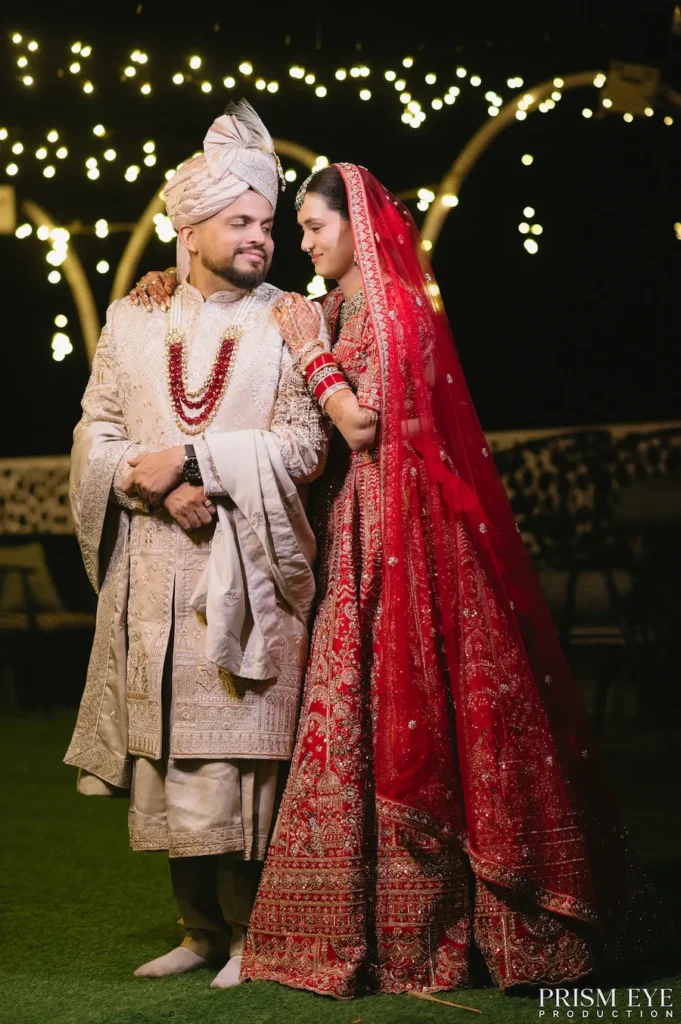 Elegant wedding reception portrait of bride and groom under decorative lights