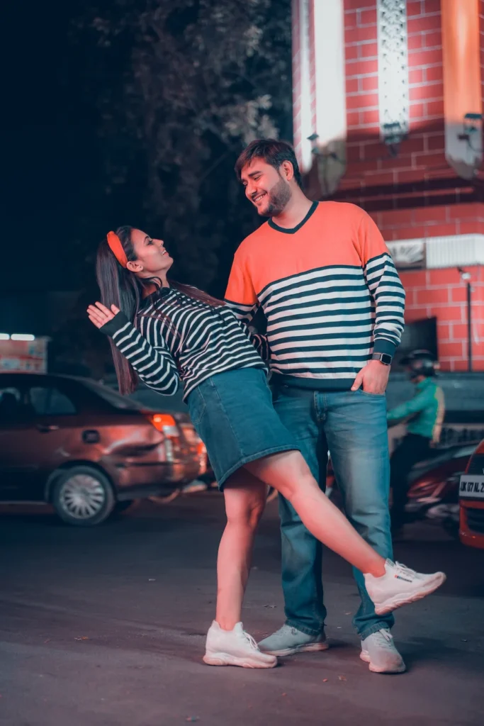 Couple posing on Mall Road during a nighttime pre-wedding shoot in Mussoorie