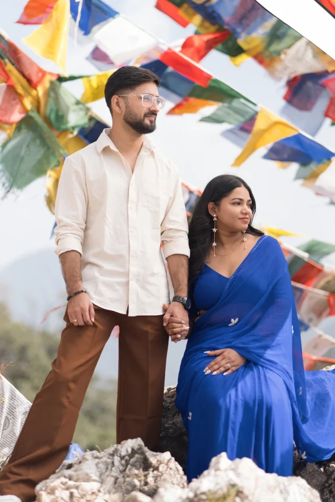 Romantic pre-wedding portrait at The Dalai Hills Mussoorie with colorful Tibetan prayer flags
