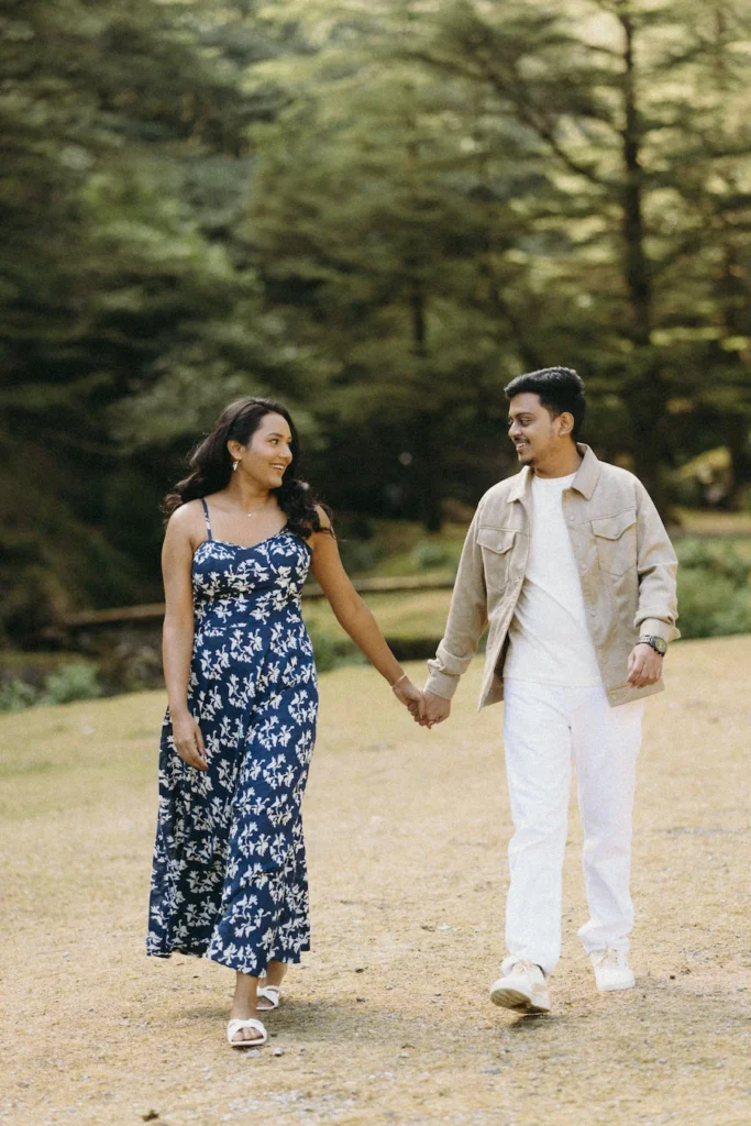 Couple walking hand in hand during a romantic pre-wedding shoot in Dhanaulti surrounded by cedar forests