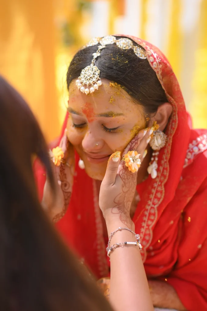 Bride enjoying candid haldi ritual moments at Uttarakhand destination wedding 