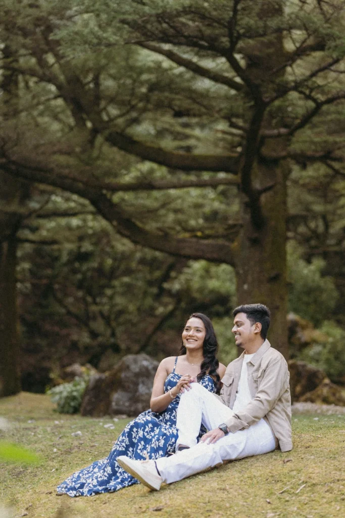 Couple sitting together in the scenic pine forests of Dhanaulti during a pre-wedding shoot