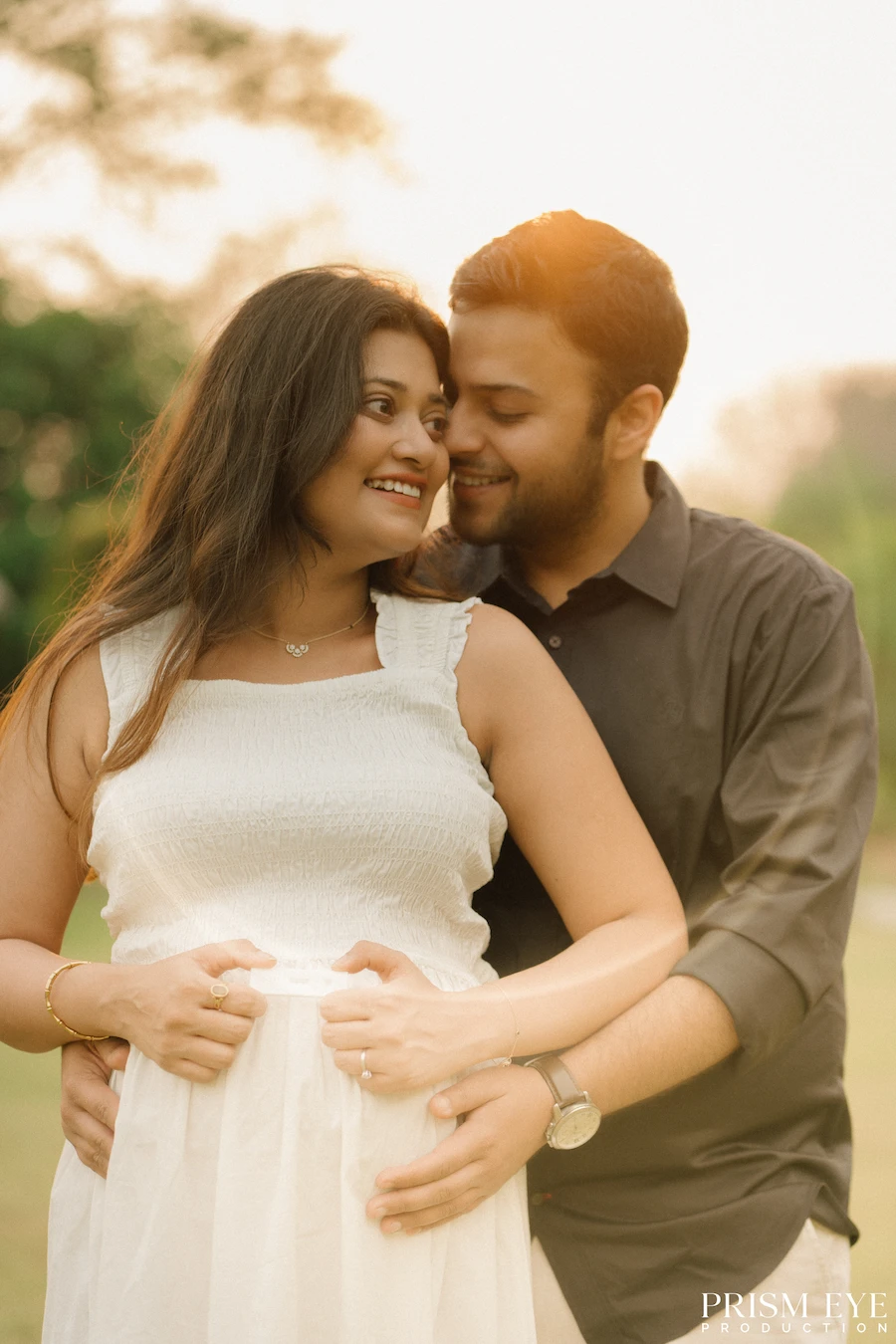 A quiet moment filled with love, anticipation, and the promise of a beautiful new beginning. Expecting couple sharing a tender maternity moment in warm sunset light
