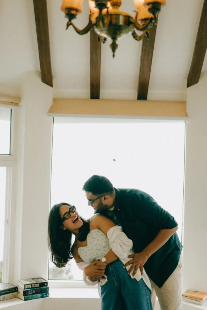 Playful couple portrait captured indoors during a pre-wedding shoot at Gun Hill Mussoorie