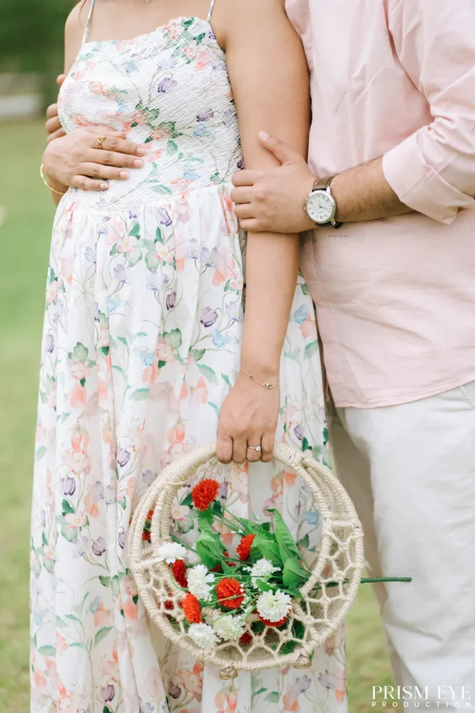 Expecting couple holding a floral basket during an outdoor maternity photoshoot