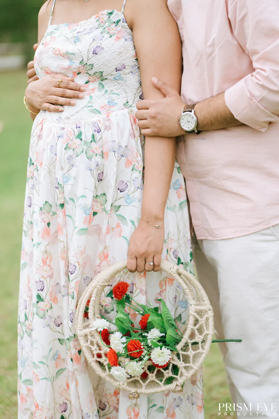 A little bloom, a little love, and a beautiful new chapter in the making. Expecting couple holding a floral basket during an outdoor maternity photoshoot