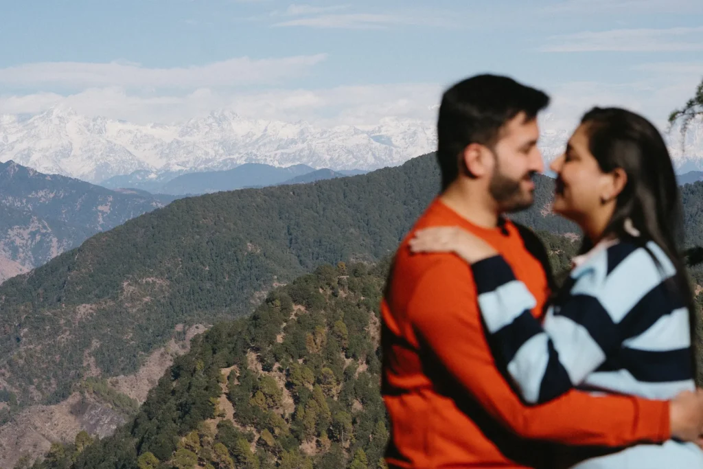 Couple enjoying a scenic pre-wedding shoot at Lal Tibba Mussoorie with panoramic Himalayan mountain views in the background