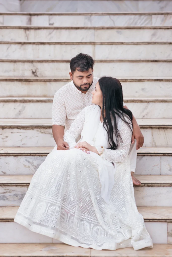 Elegant pre-wedding photography at Nag Devta Temple featuring a couple on marble temple steps