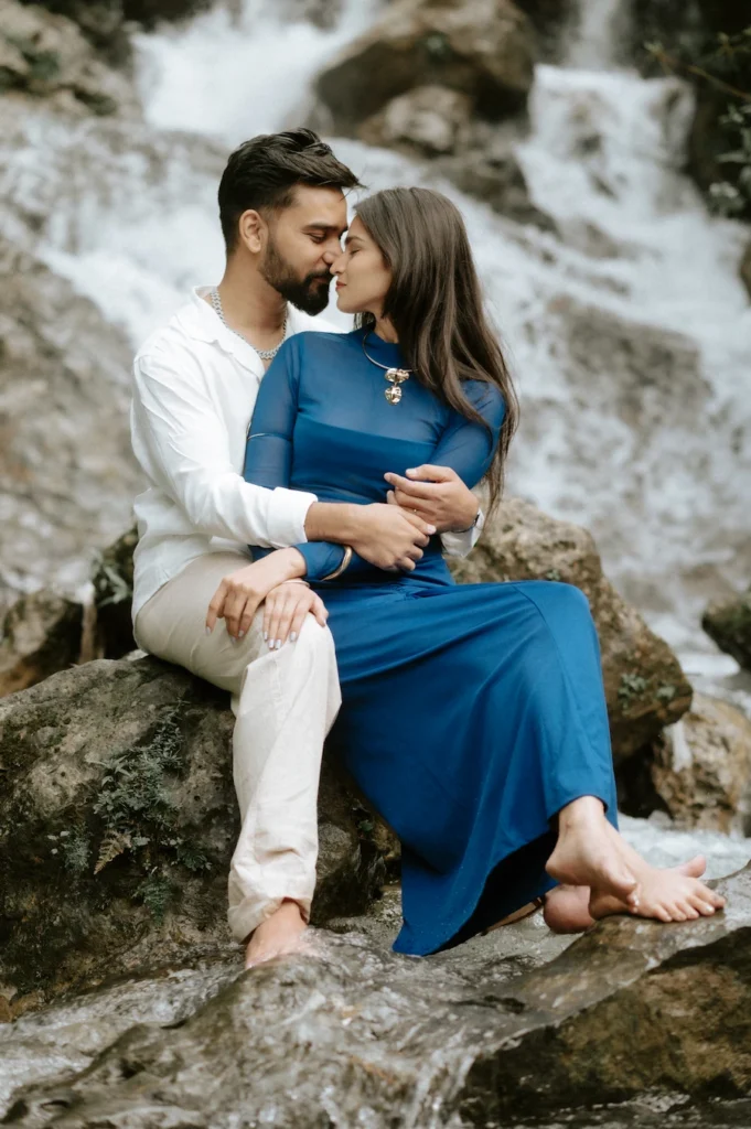 Couple sitting by Bhatta Falls during a romantic pre-wedding shoot near Mussoorie