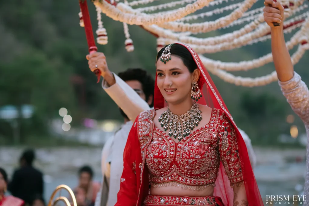 Bride making a grand entry under phoolon ki chaadar during a luxury Wedding in Rishikesh destination wedding ceremony