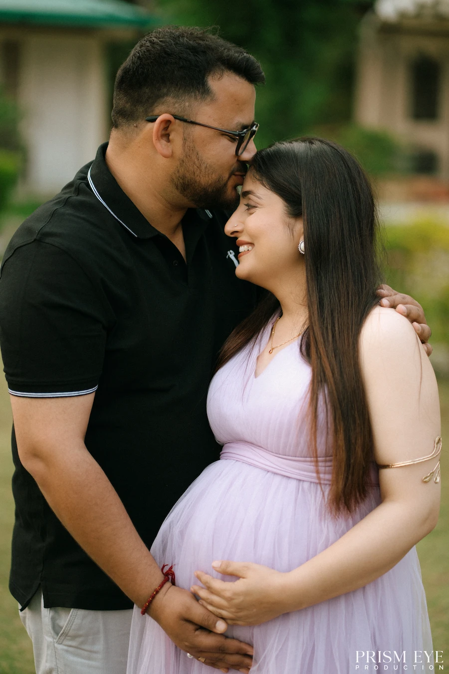 A gentle embrace, a growing family, and a love that’s only getting bigger. Expecting couple sharing a close and affectionate maternity moment outdoors