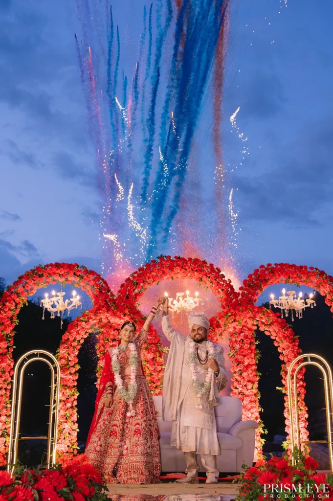Bride and groom celebrating destination wedding with fireworks at Heaven in Himalayas Rishikesh