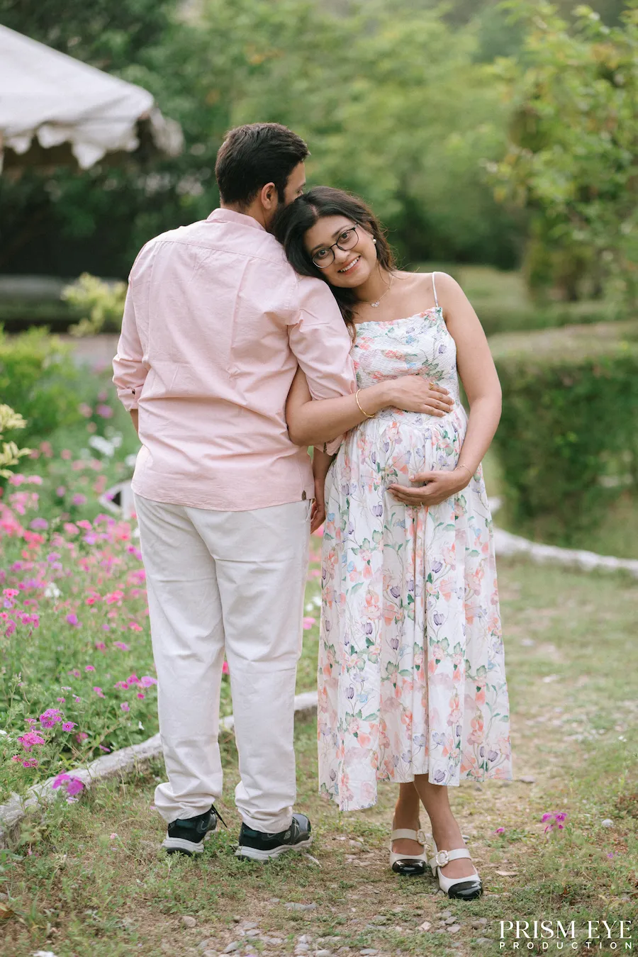 Held close, surrounded by nature, and waiting for their little miracle. Expecting couple sharing a tender embrace during a maternity photoshoot at Shastradhara