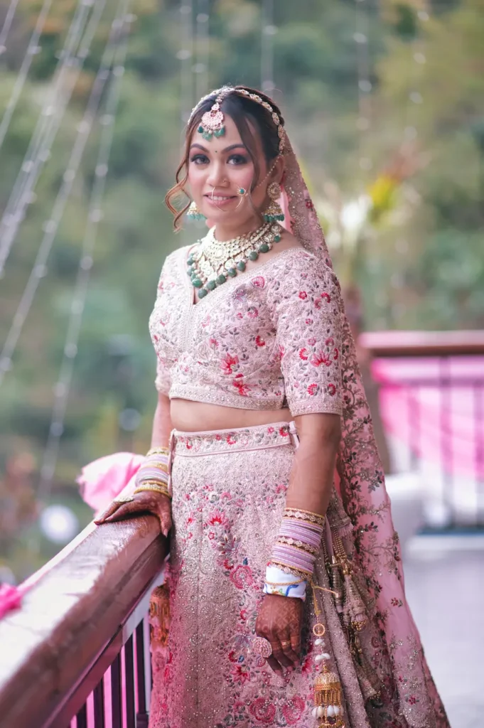 Bride posing gracefully on a balcony in embroidered wedding attire before the ceremony