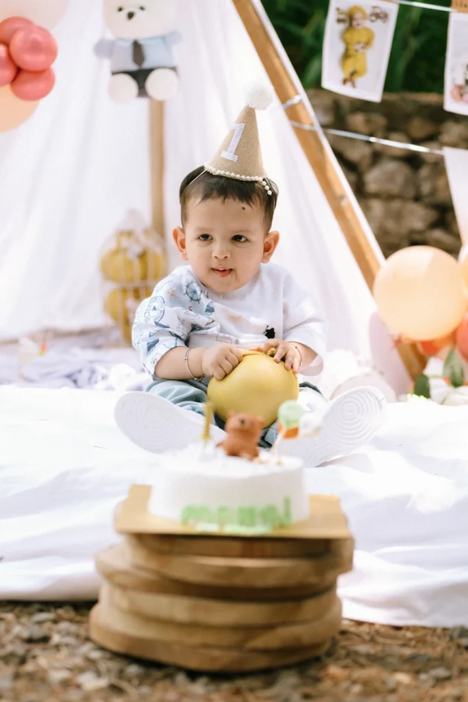 Baby Manraj holding a yellow balloon during his cake smash photoshoot in Mussoorie