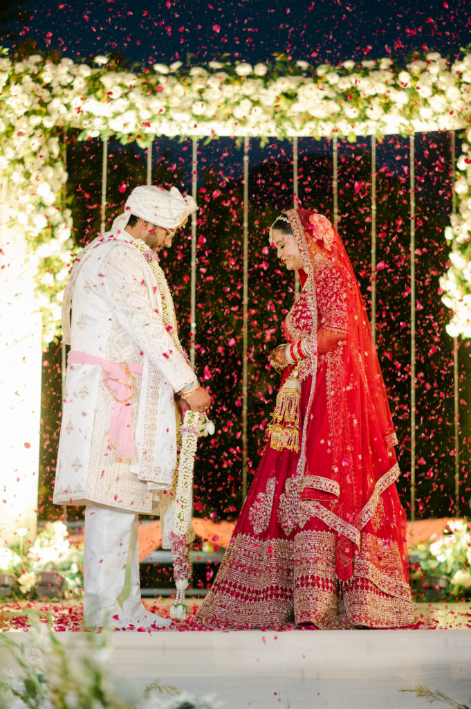 Candid varmala moment during a daytime Indian wedding in Dehradun.