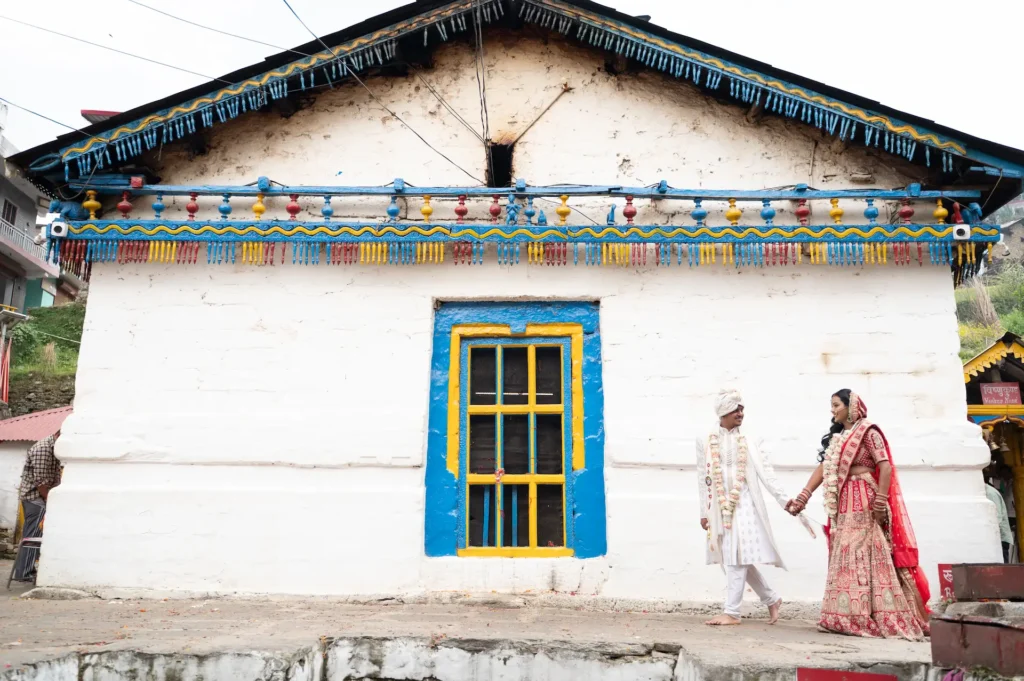 Newly married couple walking beside an ancient Hindu shrine after their traditional wedding ceremony.
