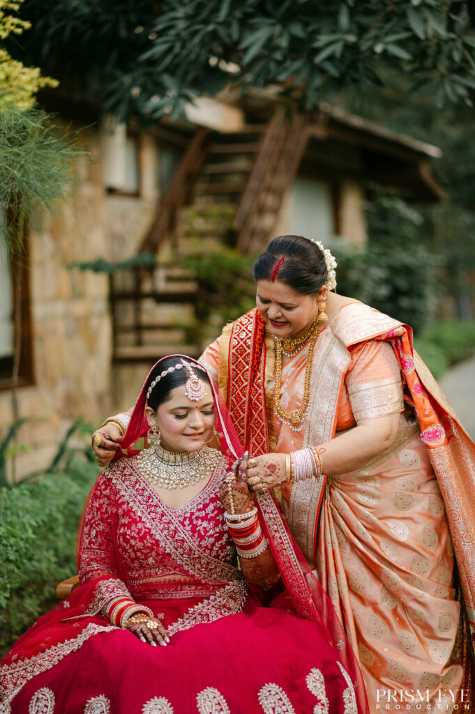 Mother helping the bride get ready before the wedding ceremony in Dehradun.