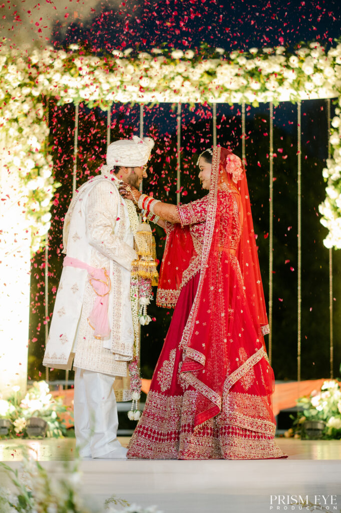 Bride and groom exchanging varmala during a luxury day wedding ceremony in Dehradun
