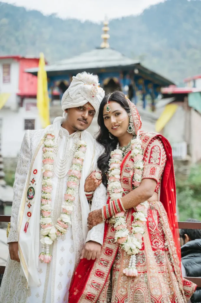 Newly married couple smiling together with the historic shrine in the background.