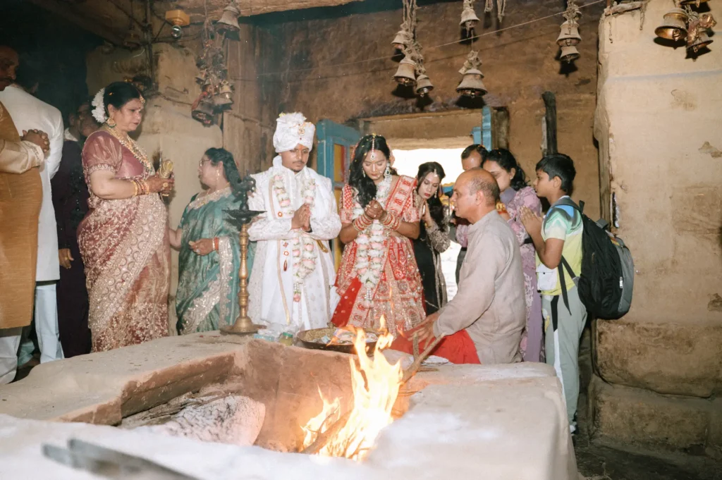 Bride and groom performing sacred Hindu wedding rituals beside the eternal sacred fire.