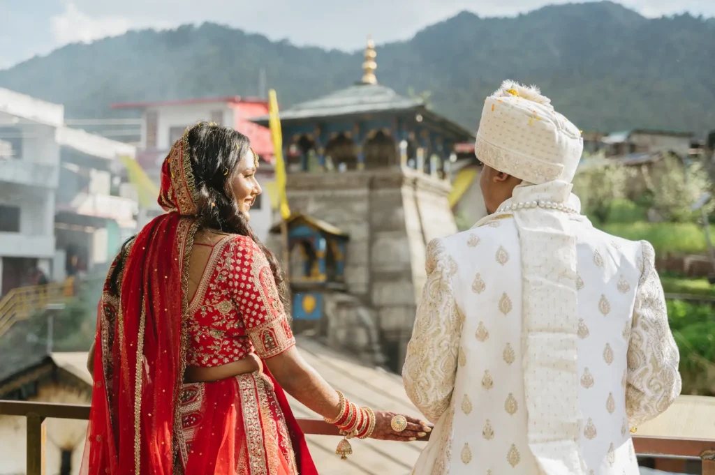 Bride and groom overlooking Triyuginarayan Temple after their traditional Hindu wedding in Uttarakhand.