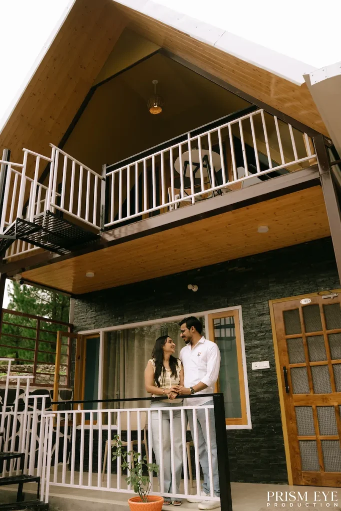 Couple standing on the balcony at Bann Resort in Chakrata
