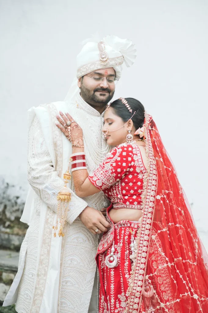 Bride and groom sharing a warm wedding portrait, with the bride resting her hand on the groom’s chest.