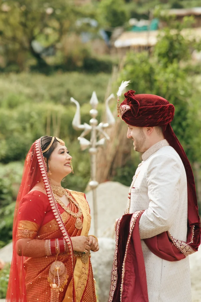 Bride and groom sharing a warm glance in traditional wedding attire