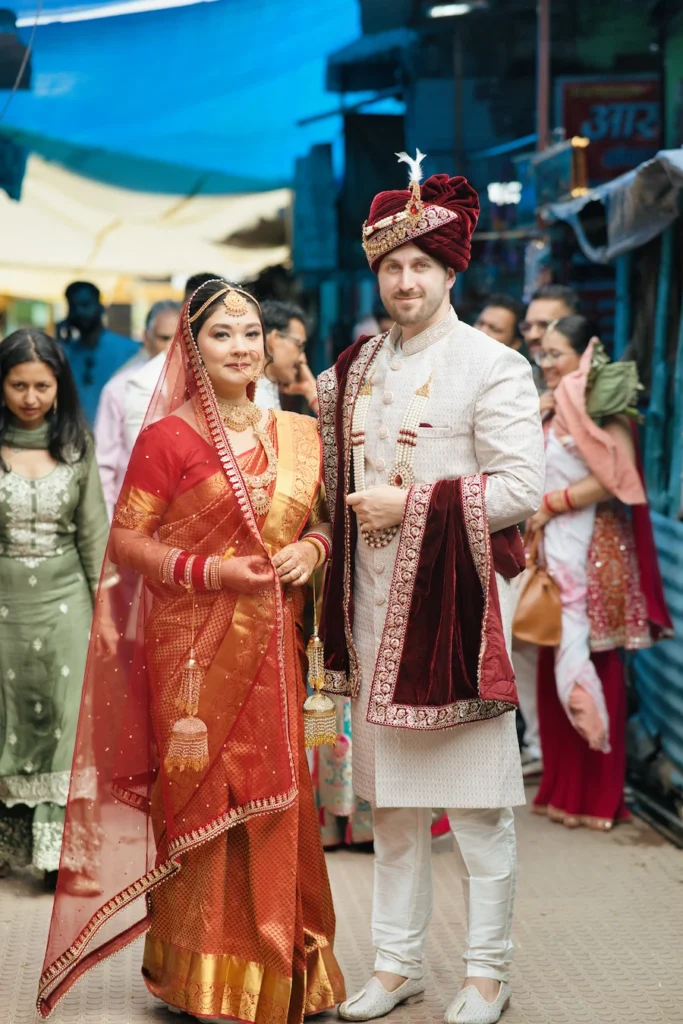 Bride and groom standing together among guests at a temple wedding ceremony