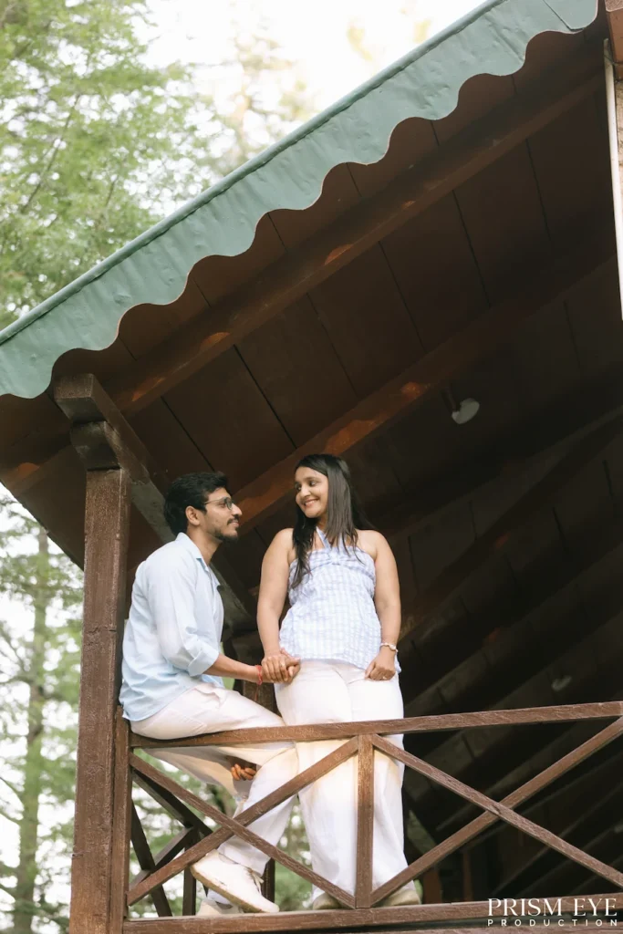 Couple enjoying a quiet moment on a cottage balcony in Koti, Kansar