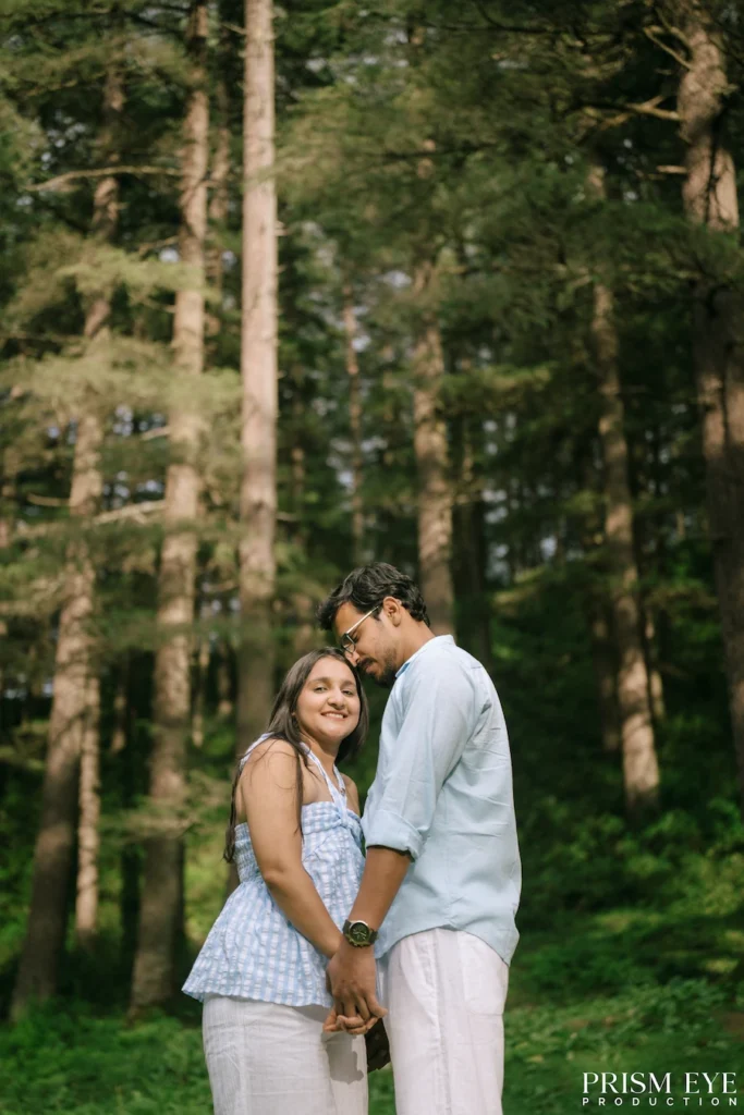 Couple sharing a romantic moment among deodar trees in Kansar, Chakrata