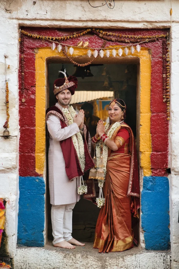 Bride and groom standing together in a decorated heritage doorway during their wedding