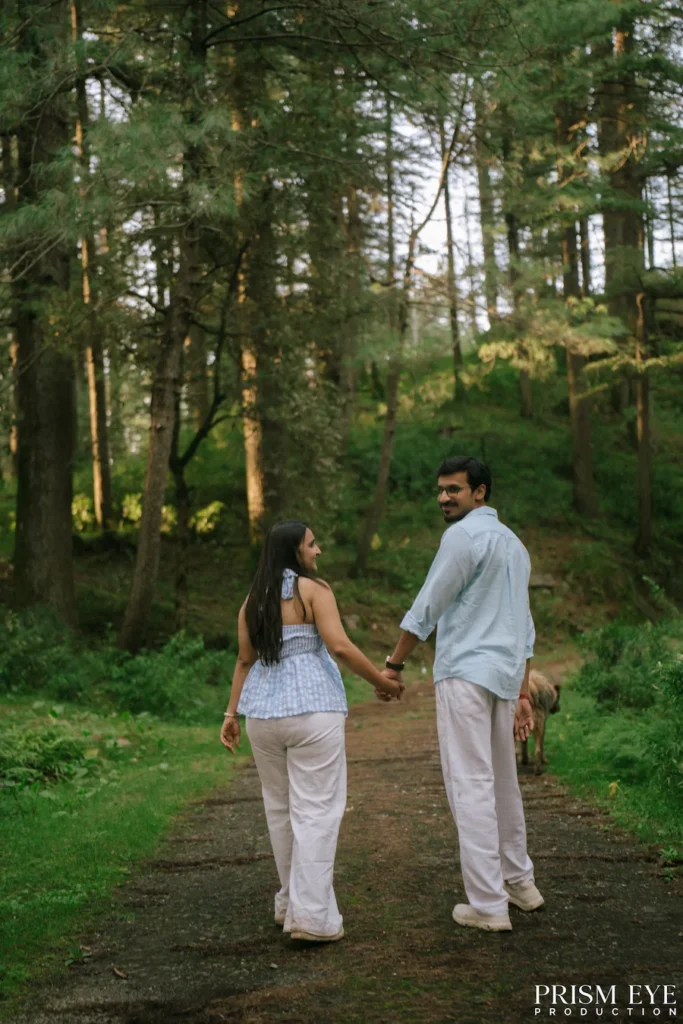 Couple walking hand in hand through Koti forest in Chakrata
