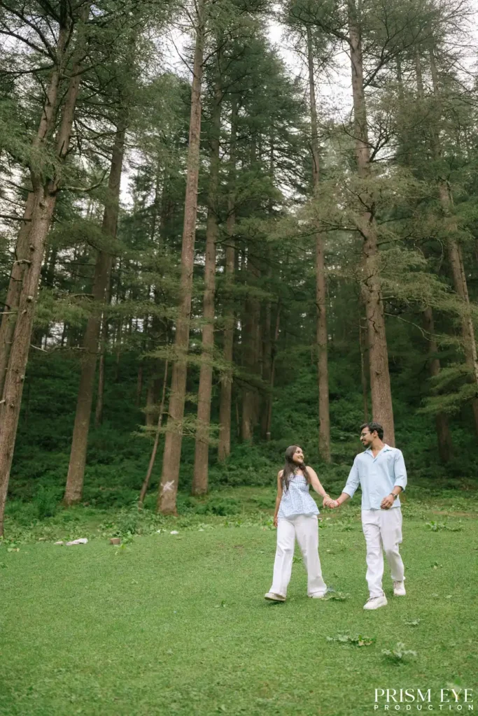 Pre-wedding couple walking among deodar trees in Kansar, Chakrata