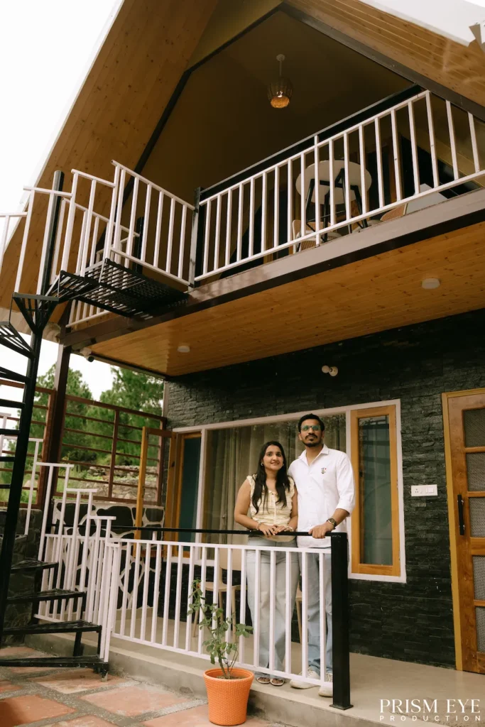 Couple posing on the balcony of a mountain stay in Lokhandi, Chakrata