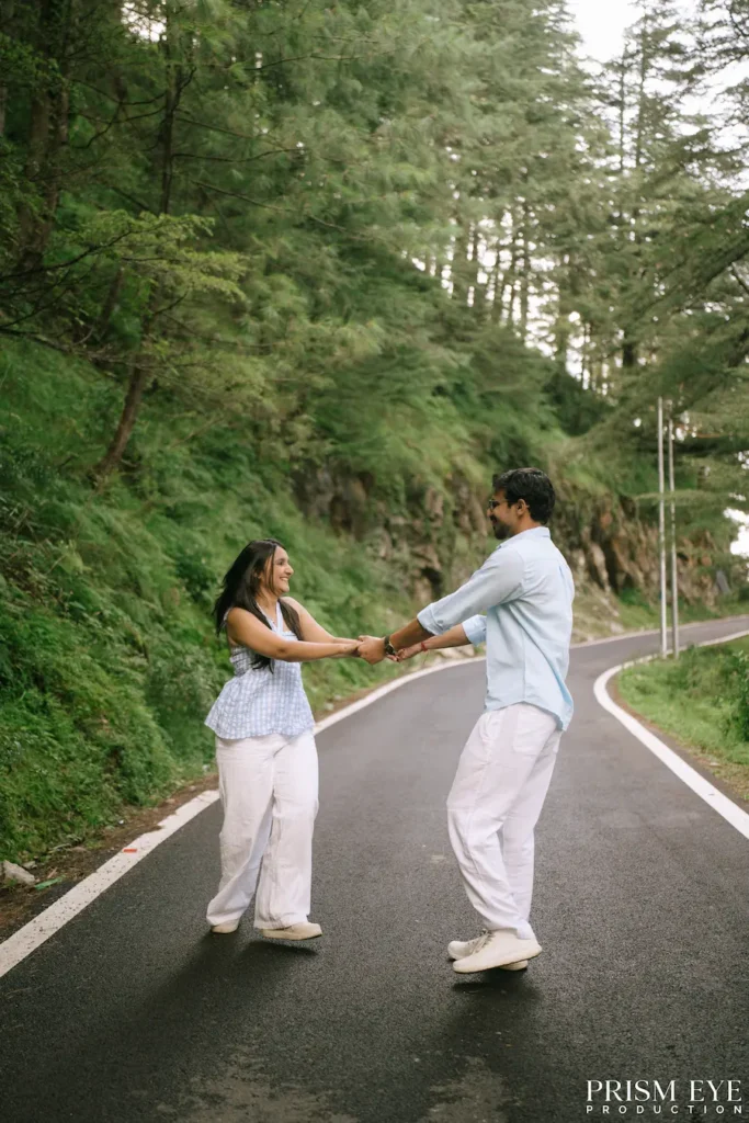 Couple sharing a playful moment on a forest road in Koti, Kansar