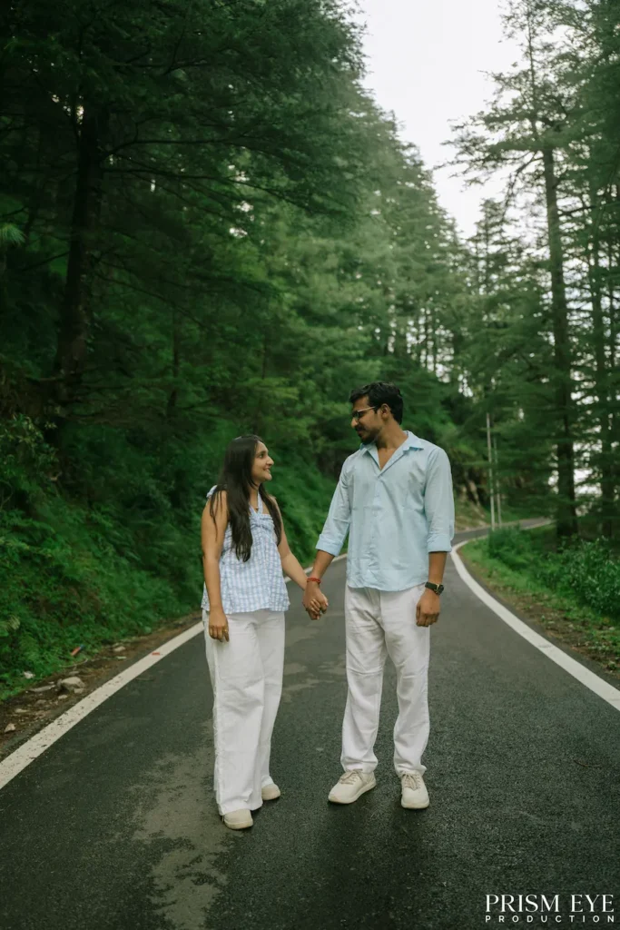Couple walking hand in hand on a forest road in Koti, Chakrata