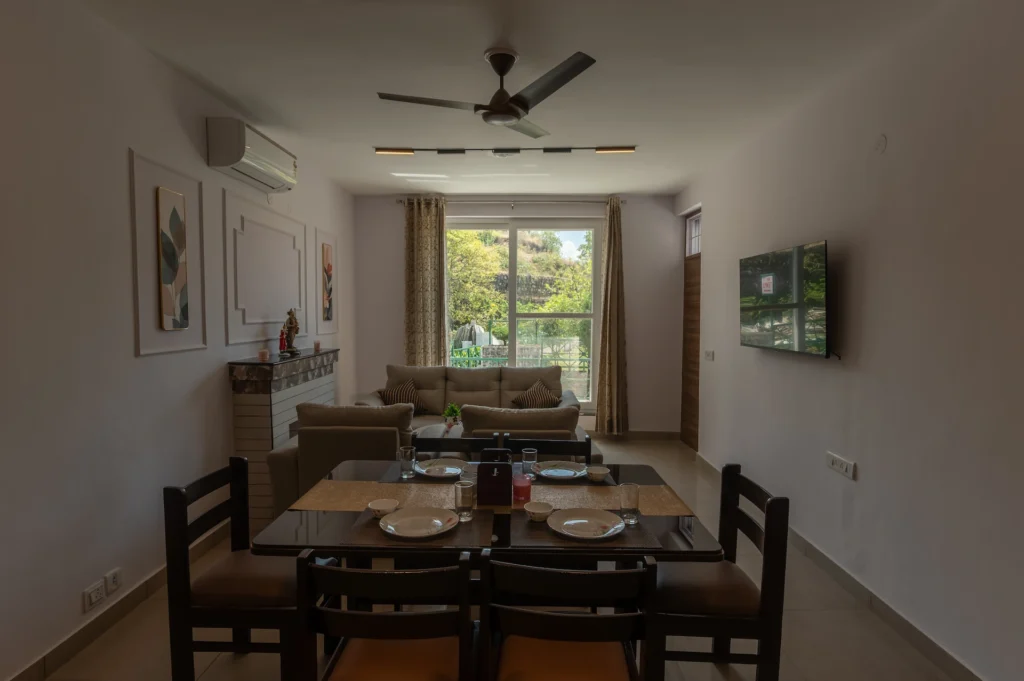 Premium villa dining and living area with mountain view in Jharipani, Mussoorie, Uttarakhand.