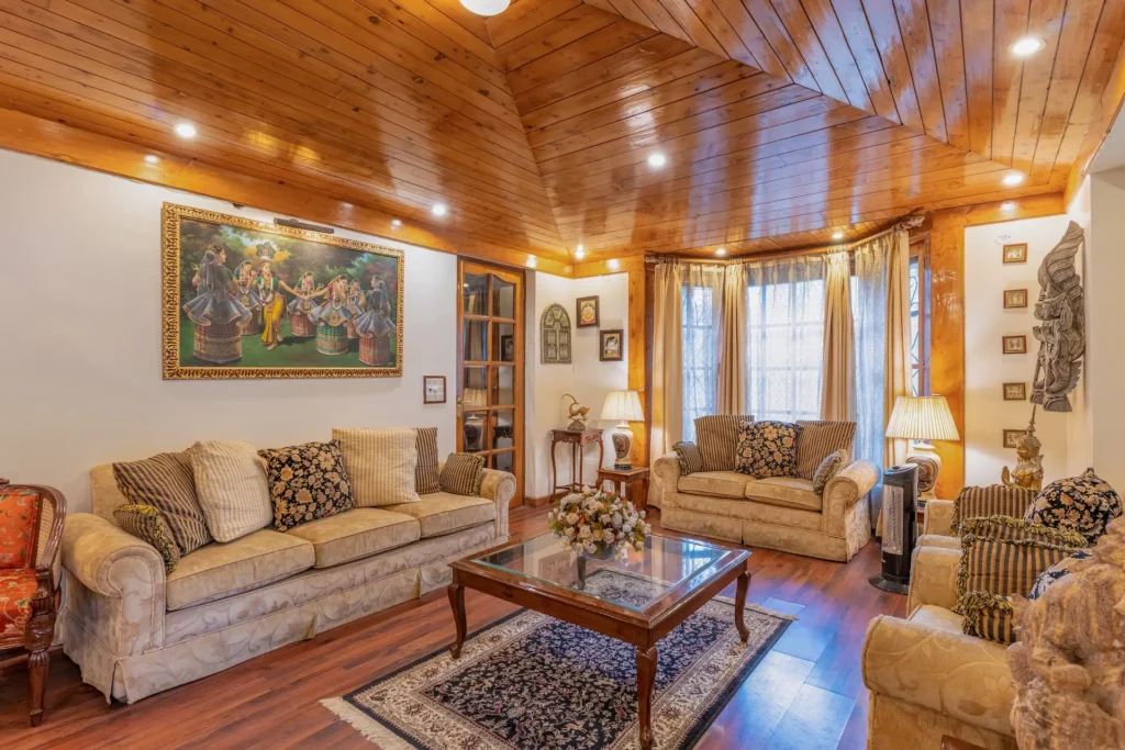 Elegant luxury living room with wooden ceiling and premium seating in Rishikesh, Uttarakhand.