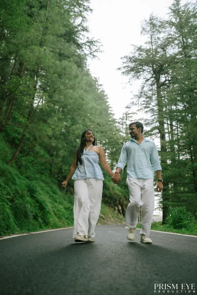 Couple walking hand in hand on a forest road in Koti Kansar, Chakrata