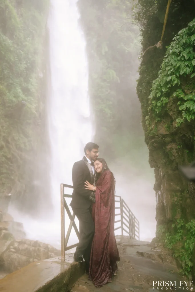 Couple embracing beside Tiger Falls in Chakrata