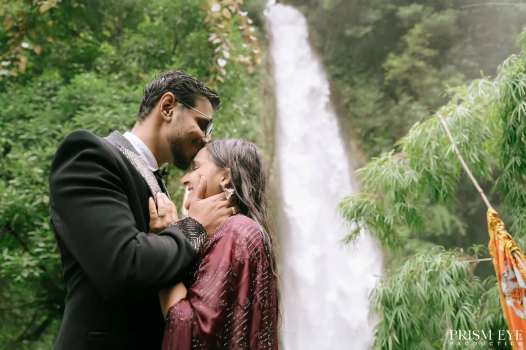 Couple sharing an intimate moment at Tiger Falls in Chakrata