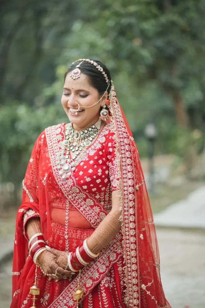 Bride portrait captured by a wedding photographer cost in Dehradun package, showcasing natural smile and traditional elegance.