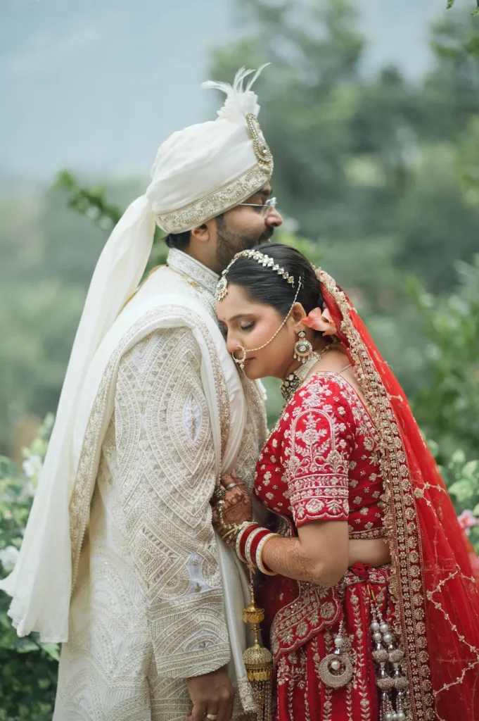 Bride and groom sharing a tender wedding moment in traditional attire.