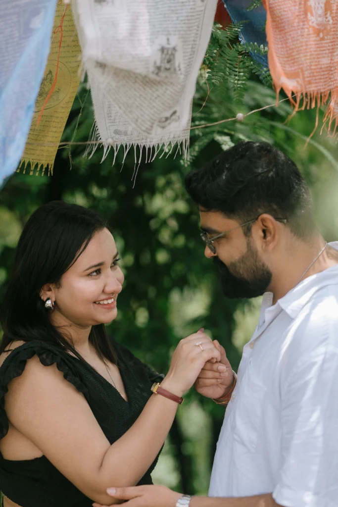 A couple smiling and holding hands during a sweet outdoor moment