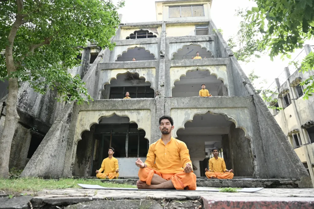 Group meditation and yoga session during a cultural event. Group yoga and meditation session at a cultural event in Dehradun
